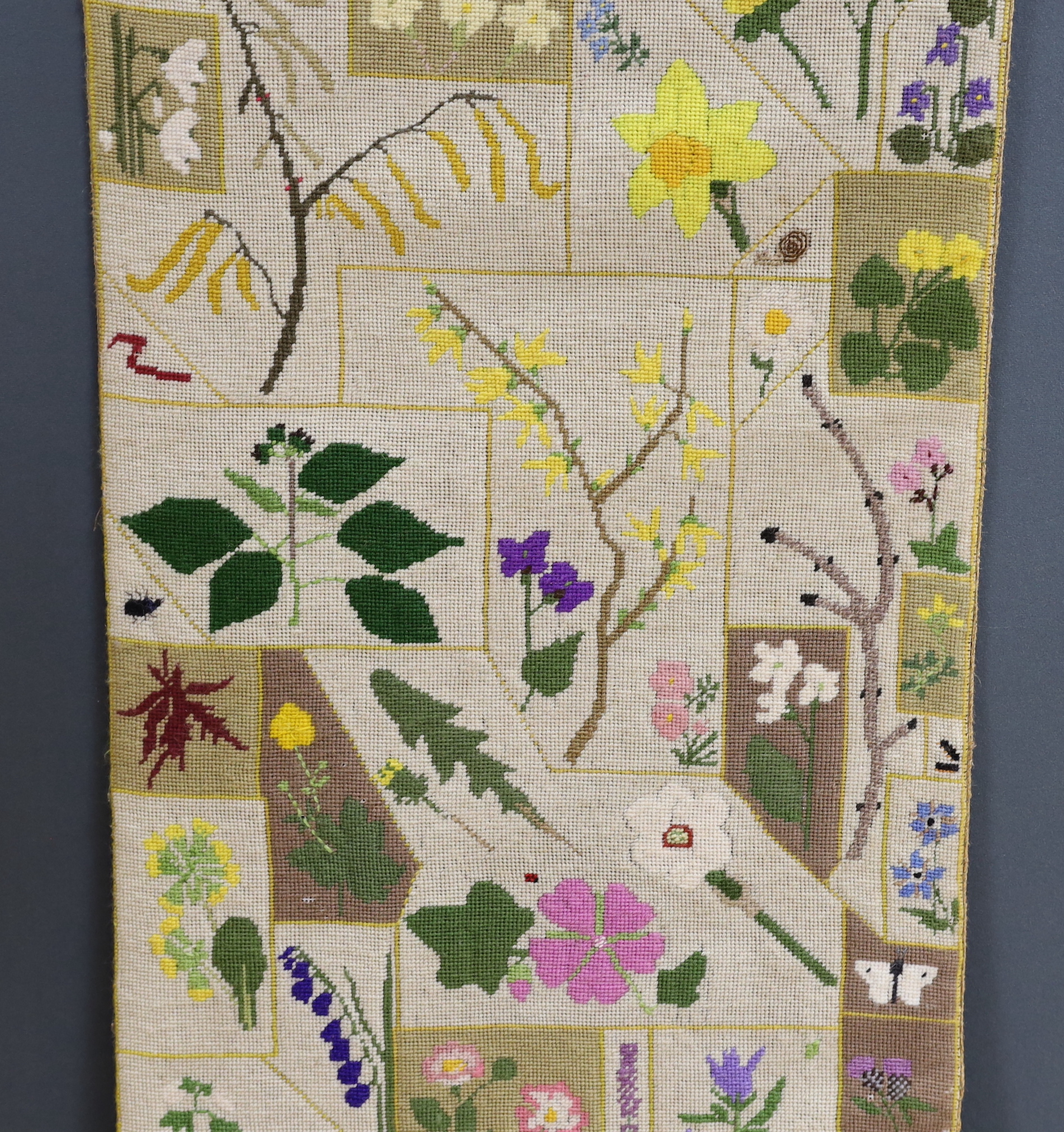 A cross-stitch wall hanging of wildflowers, 140cm high